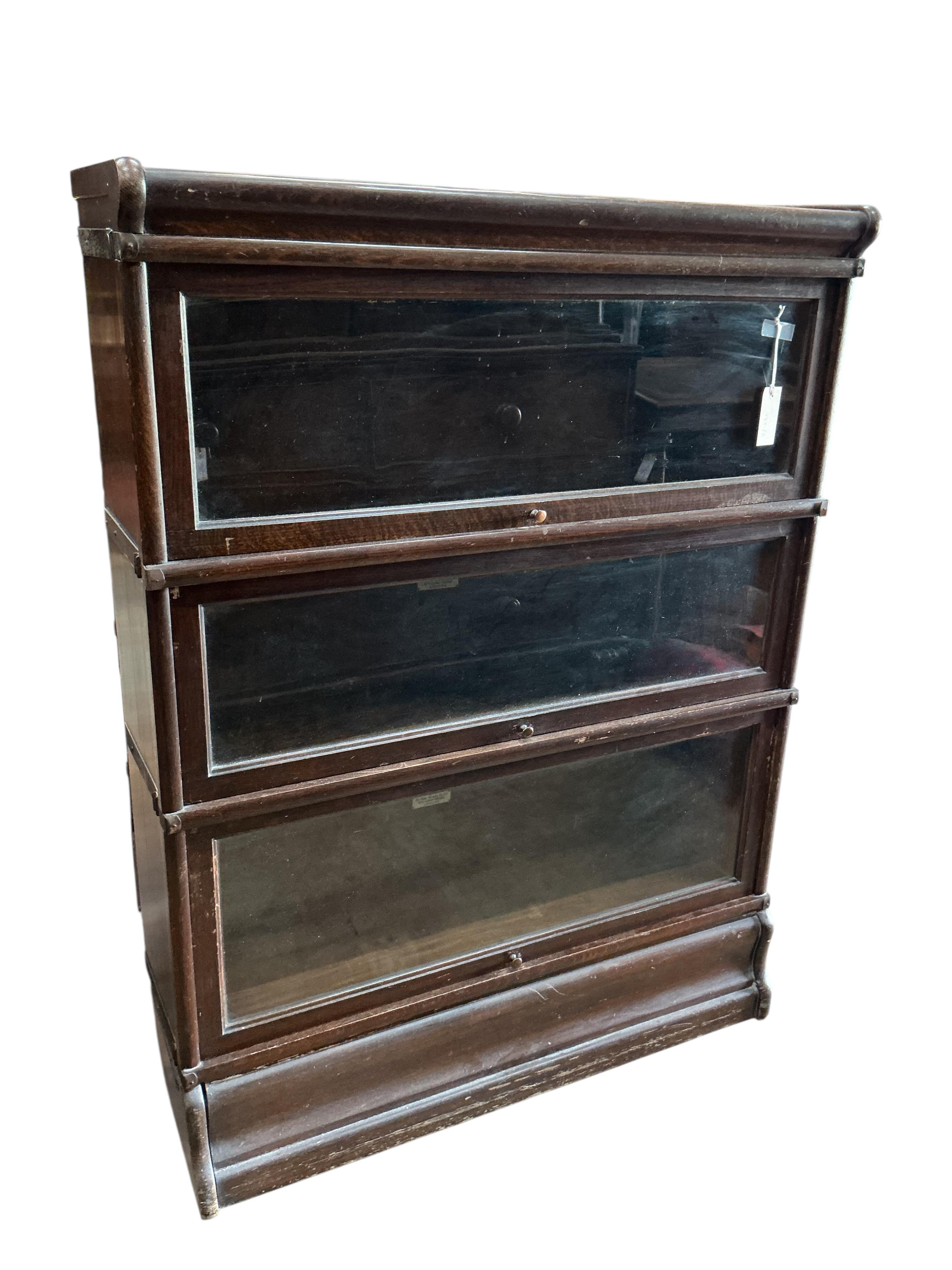 A Globe Wernicke style oak three section bookcase, width 86cm, depth 27cm, height 115cm